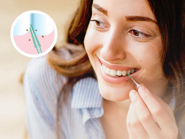 Smiling woman is cleaning between her teeth with the GUM SOFT-PICKS Original Interdental brush and an icon shows how to clean between