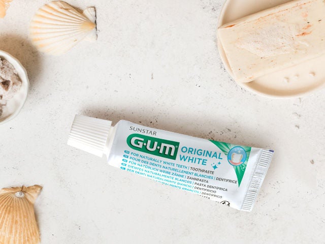 GUM ORIGINAL White toothpaste in a natural environment with shells and soap 